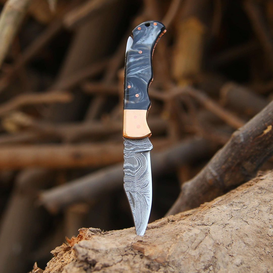 Forked knife with a decorative blade on a wooden surface