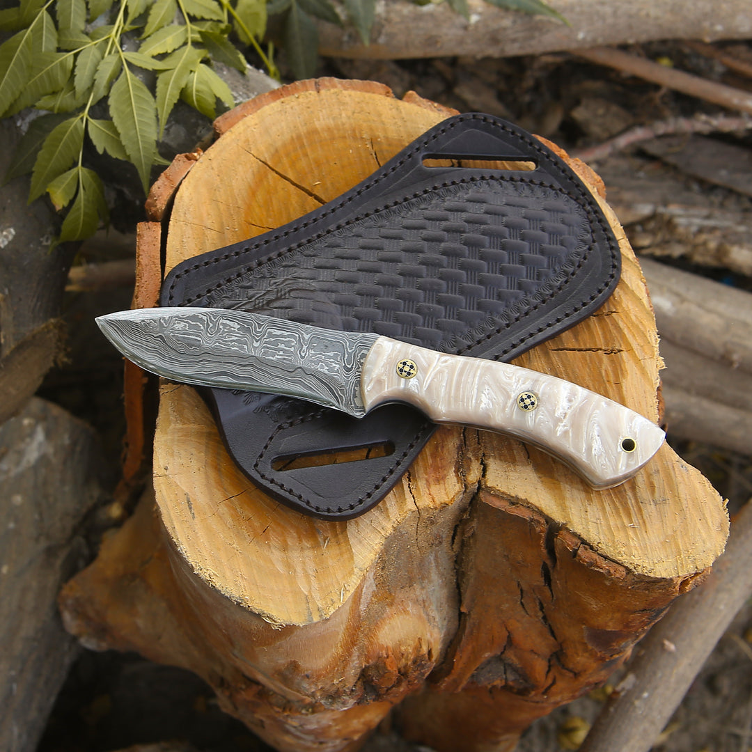 Knife with a textured handle and black sheath on a wooden log