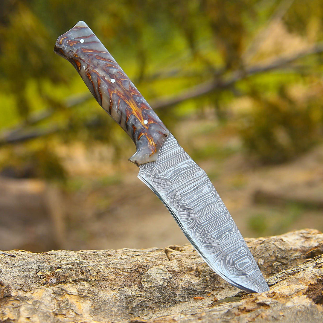 Decorative knife with a detailed blade on a wooden surface with a natural background