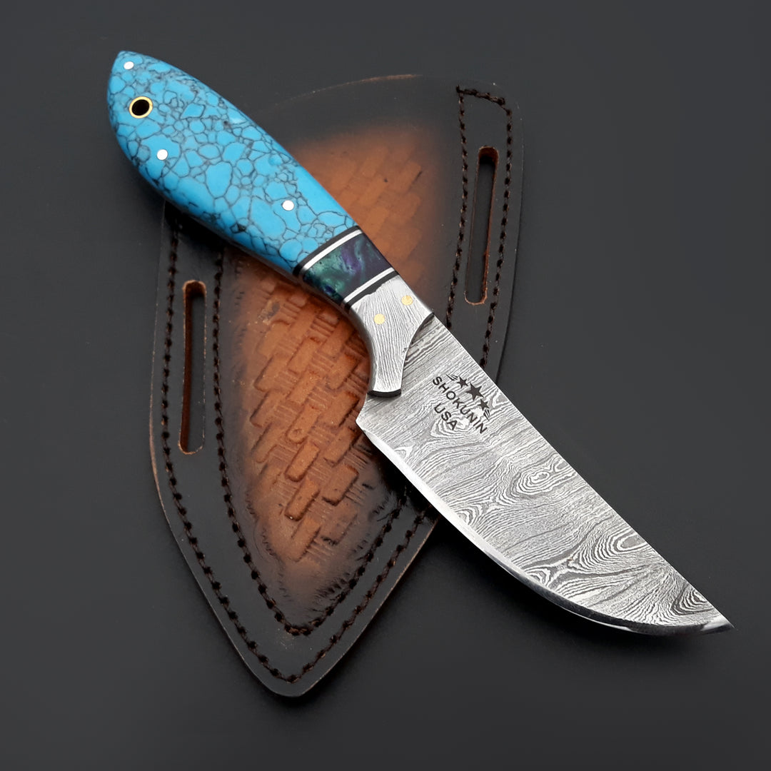 Knife with a blue handle and silver blade on a dark background