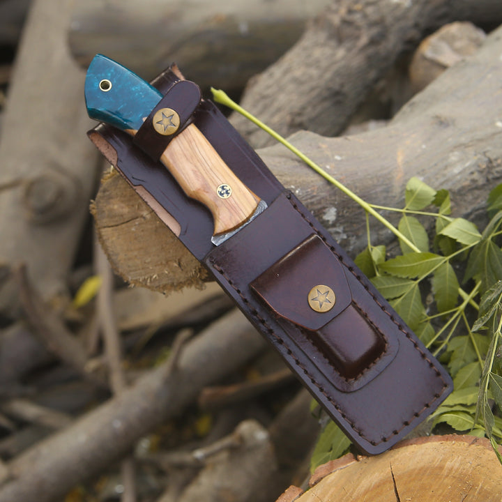 Leather knife sheath with wooden handle on a natural background