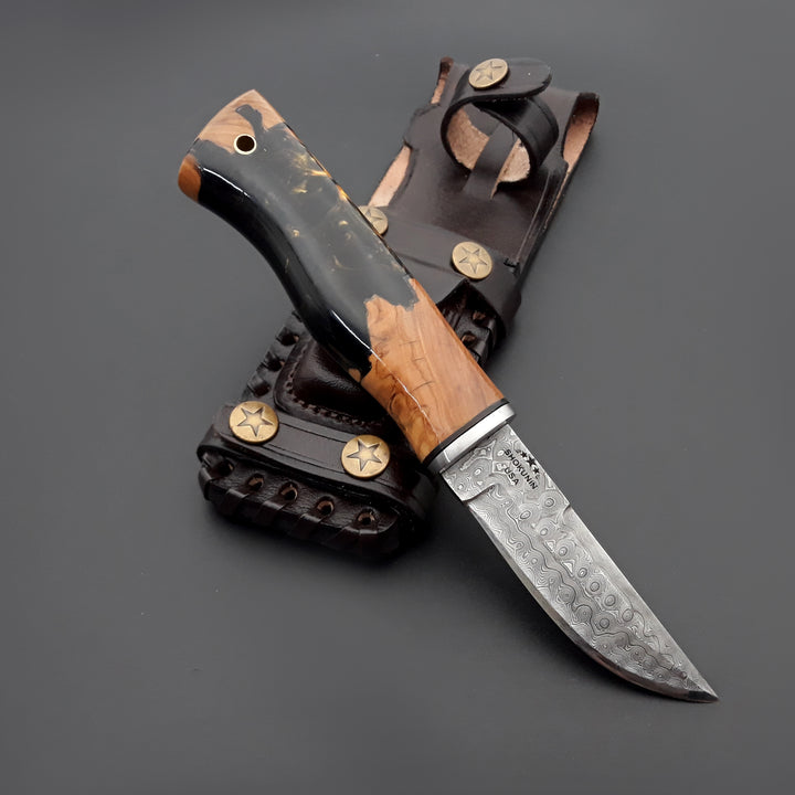 Knife with wooden handle and leather sheath on a dark background