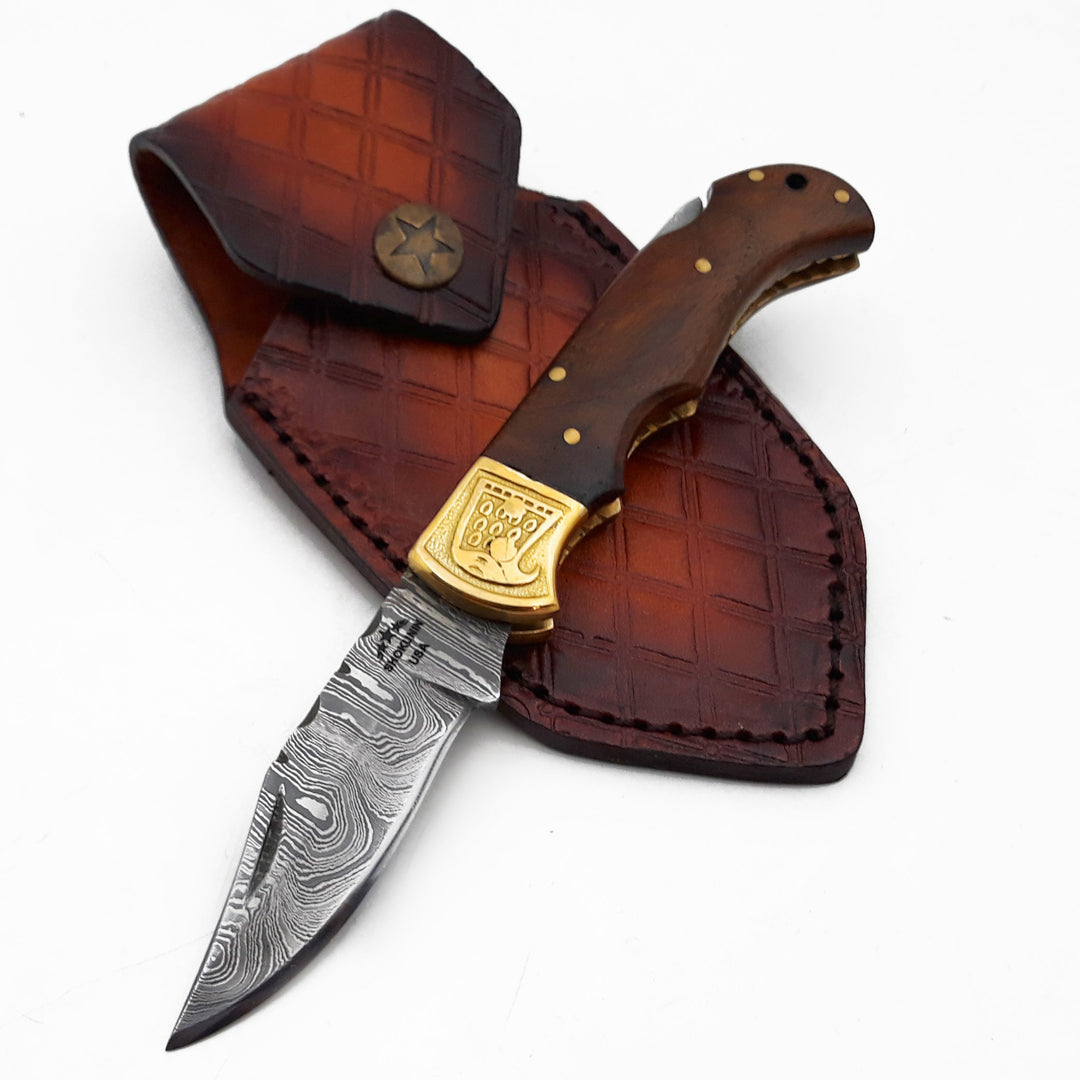 Knife with wooden handle and leather sheath on a white background