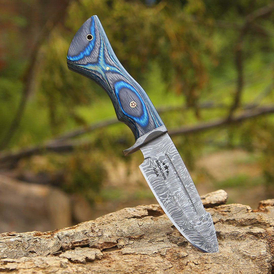 Decorative knife with a blue handle on a wooden surface